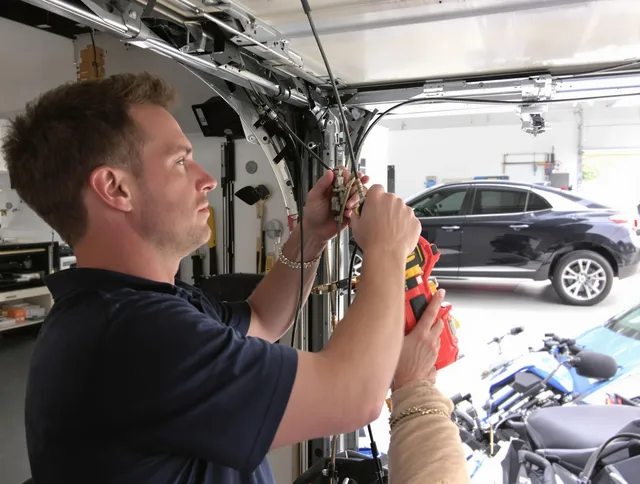 East Hampton Garage Door Repair safety certified technician performing cable replacement in East Hampton