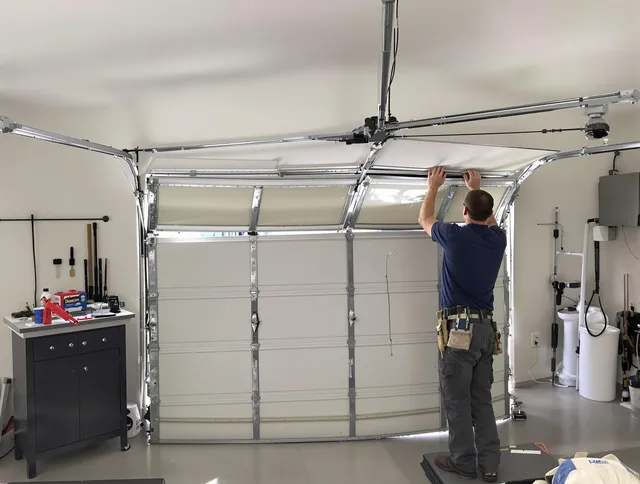 East Hampton Garage Door Repair specialist performing precise section replacement on East Hampton garage door